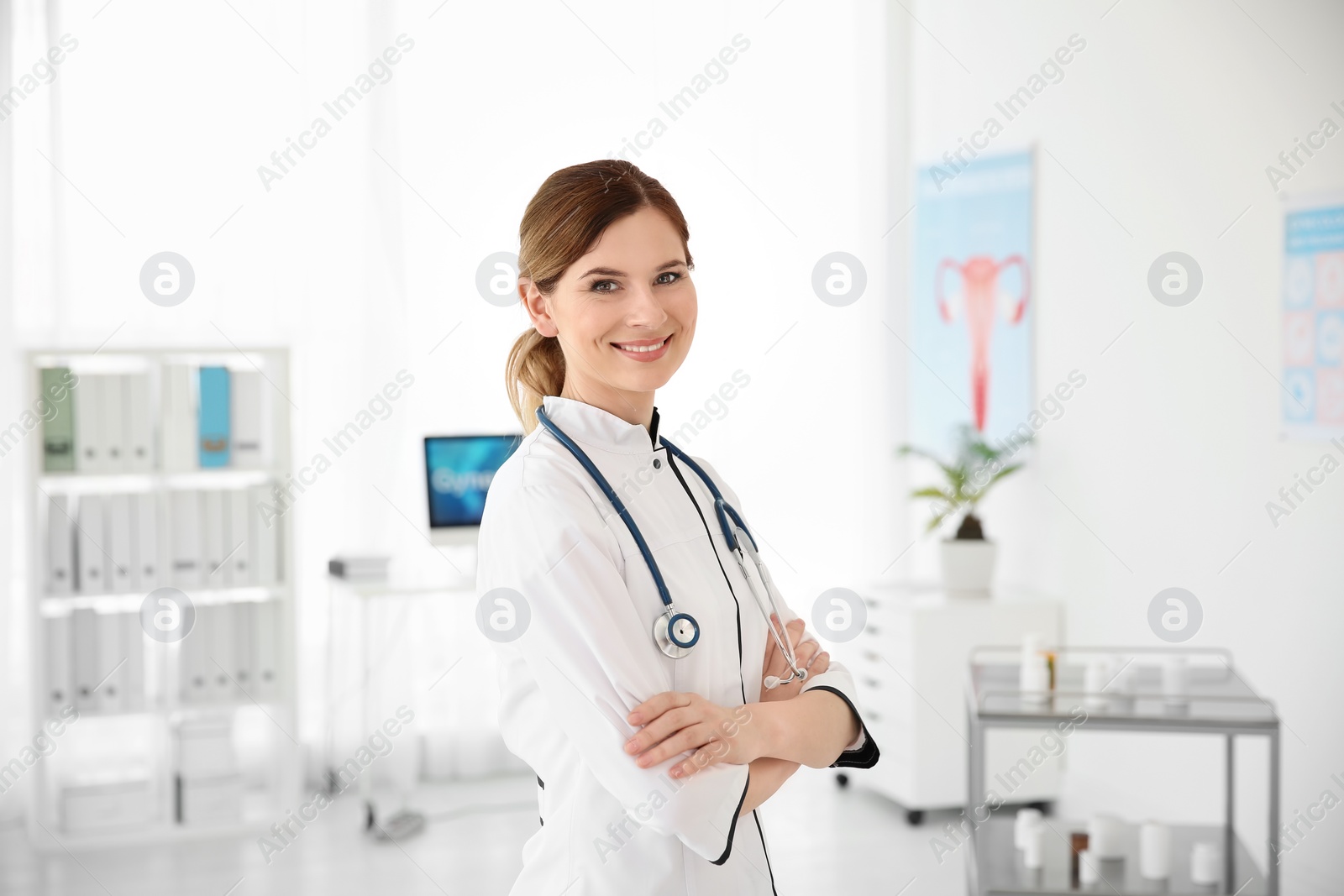 Photo of Smiling female doctor wearing uniform in modern hospital. Gynecology consultation