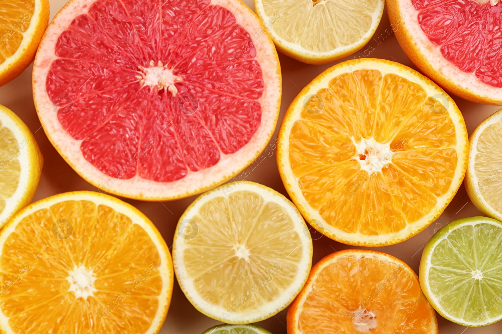 Photo of Tangerines and different citrus fruits as background, top view