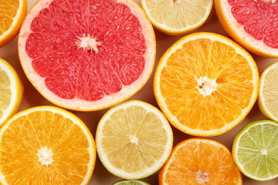 Tangerines and different citrus fruits as background, top view