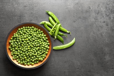 Flat lay composition with green peas on grey background