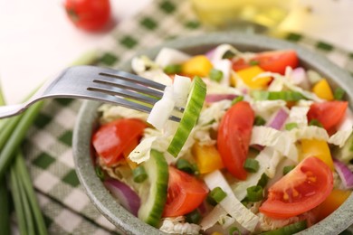 Photo of Eating delicious salad with Chinese cabbage at table, closeup