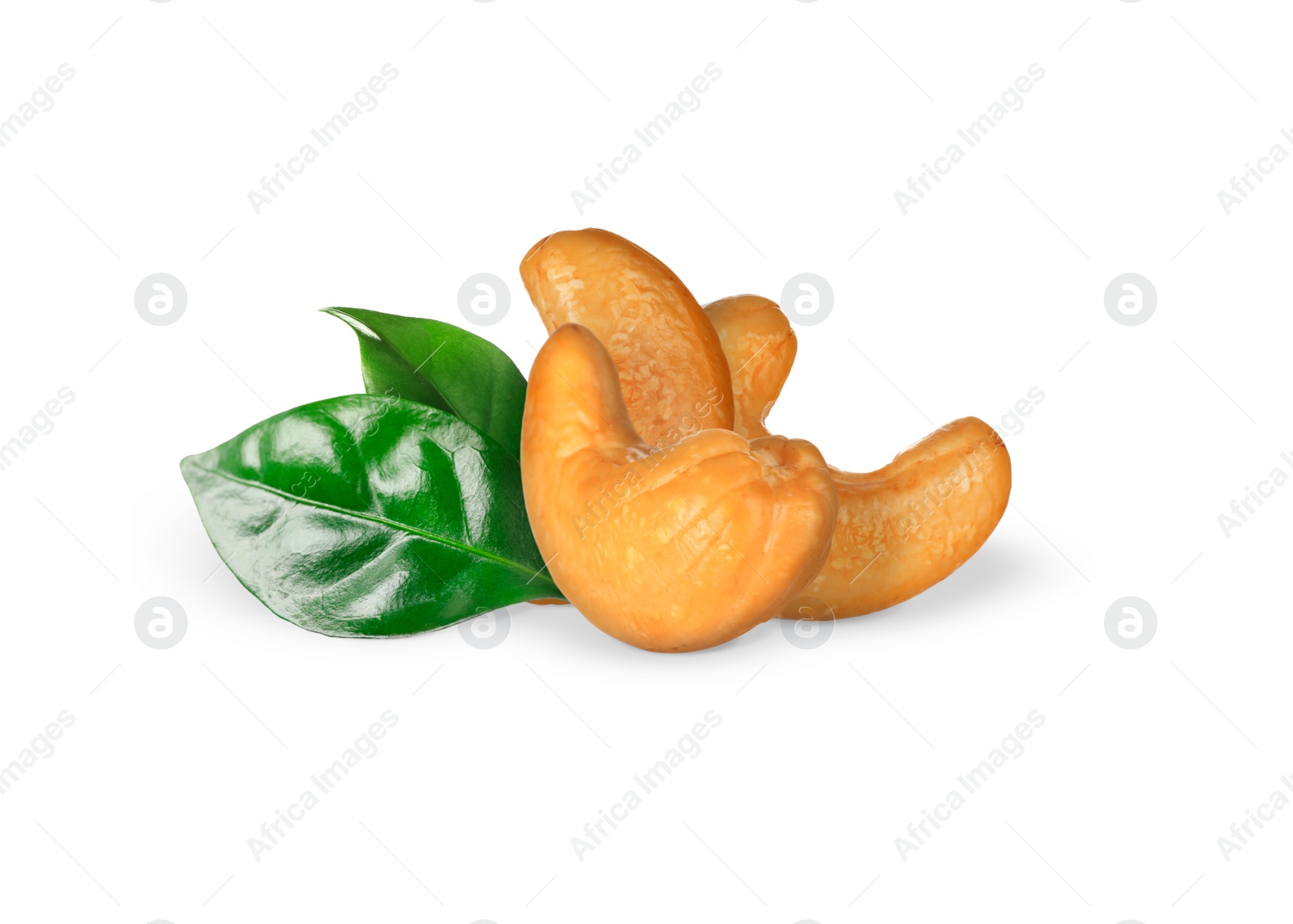 Image of Tasty cashew nuts and fresh green leaves on white background 