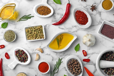 Flat lay composition with different aromatic spices on marble background
