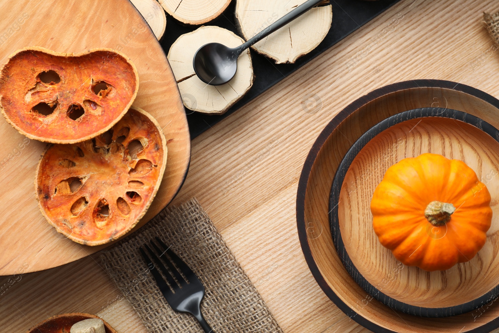 Photo of Autumn table setting with pumpkin on wooden background, flat lay