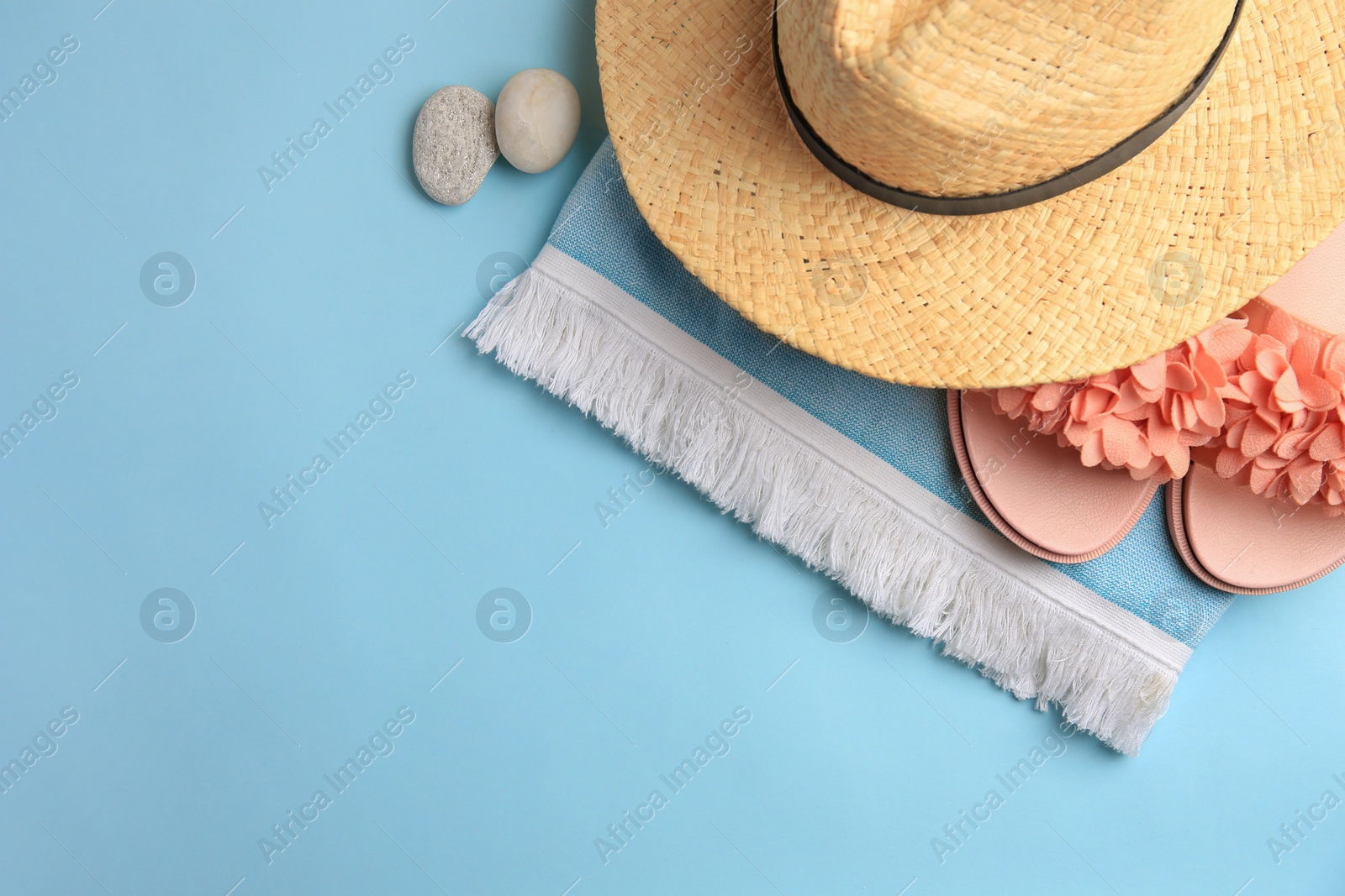 Photo of Flat lay composition with beach accessories on light blue background, space for text