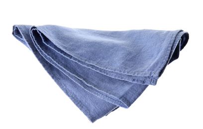 Photo of Soft blue fabric napkin isolated on white