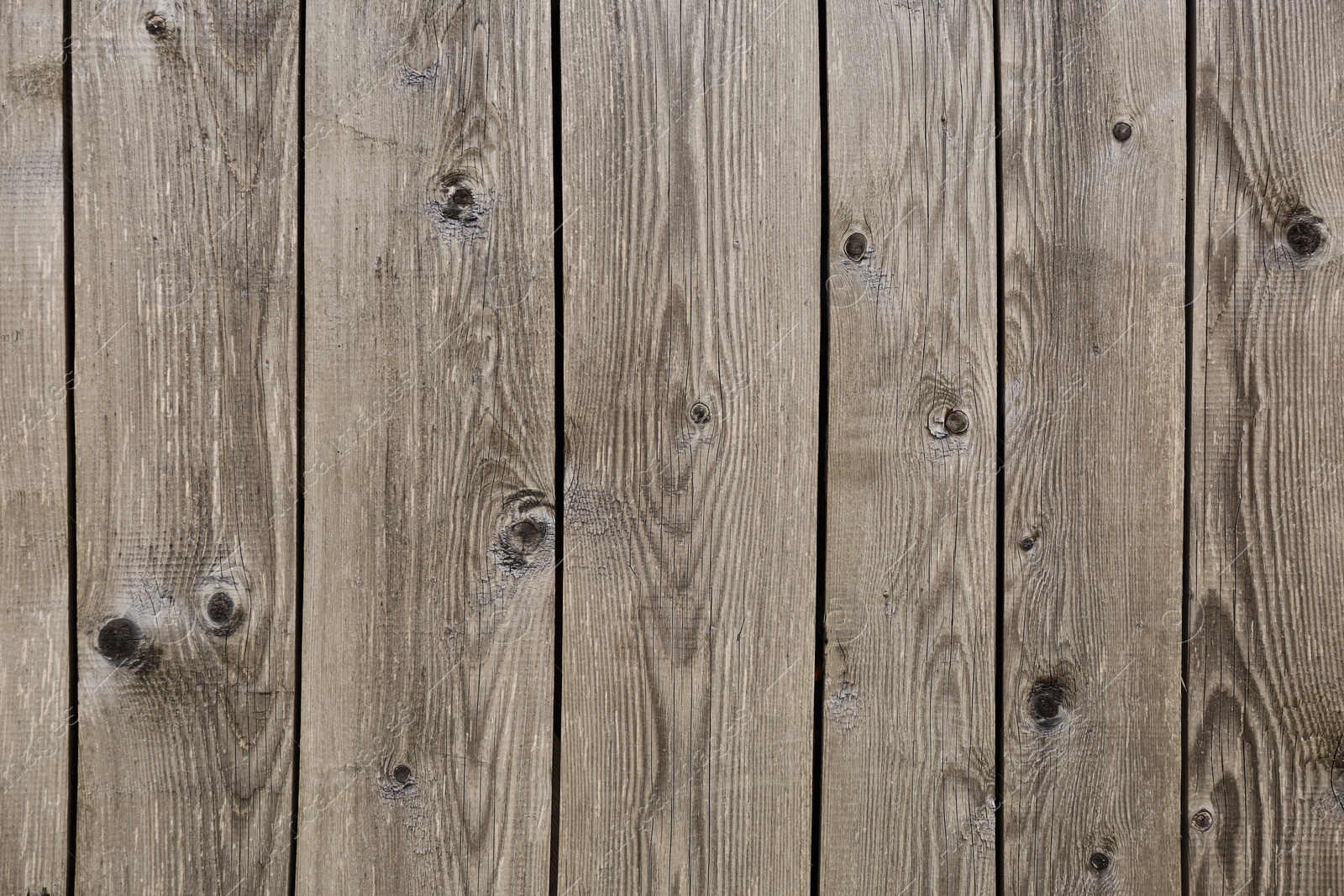 Photo of Row of wooden planks as background, fence texture