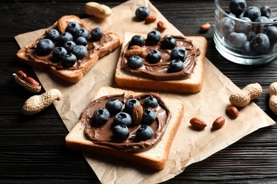 Photo of Toast bread with chocolate spread and blueberry on dark background