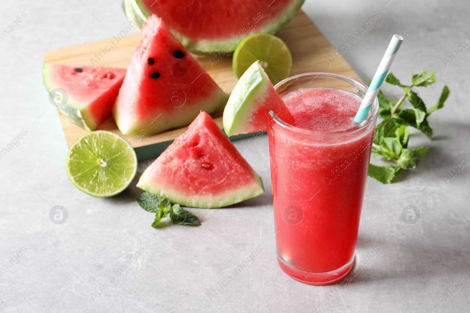 Photo of Tasty summer watermelon drink in glass and fresh fruits on table