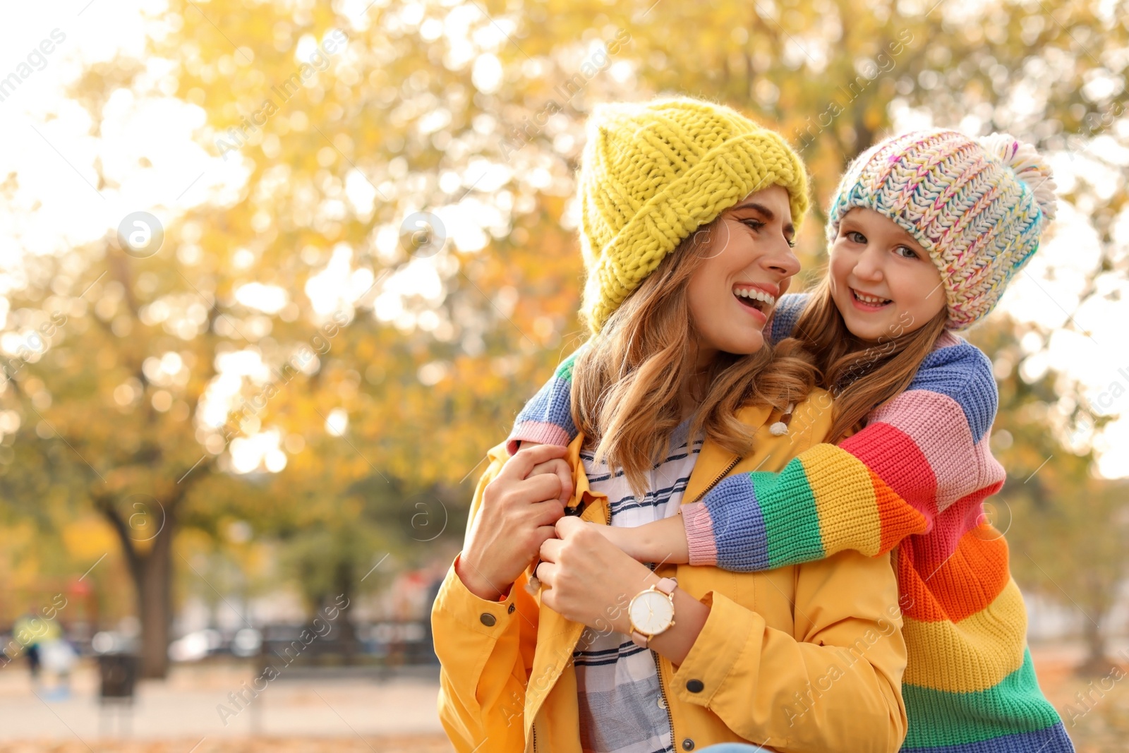 Photo of Mother with her cute daughter spending time together in park. Autumn walk