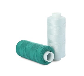 Photo of Different colorful sewing threads on white background