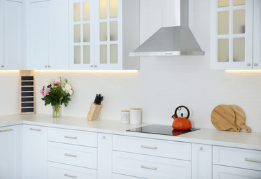 Photo of Elegant interior of new kitchen with stylish furniture