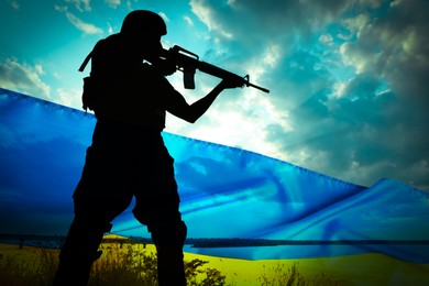 Stop war in Ukraine. Silhouette of armed soldier outdoors and Ukrainian flag, double exposure effect