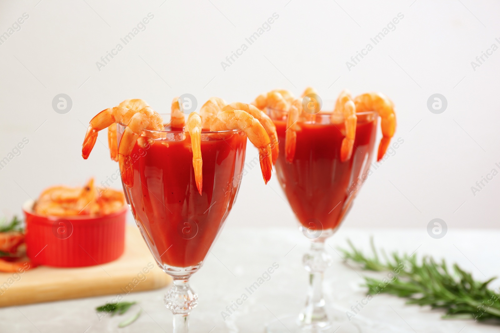 Photo of Delicious shrimp cocktail with tomato sauce served on  table