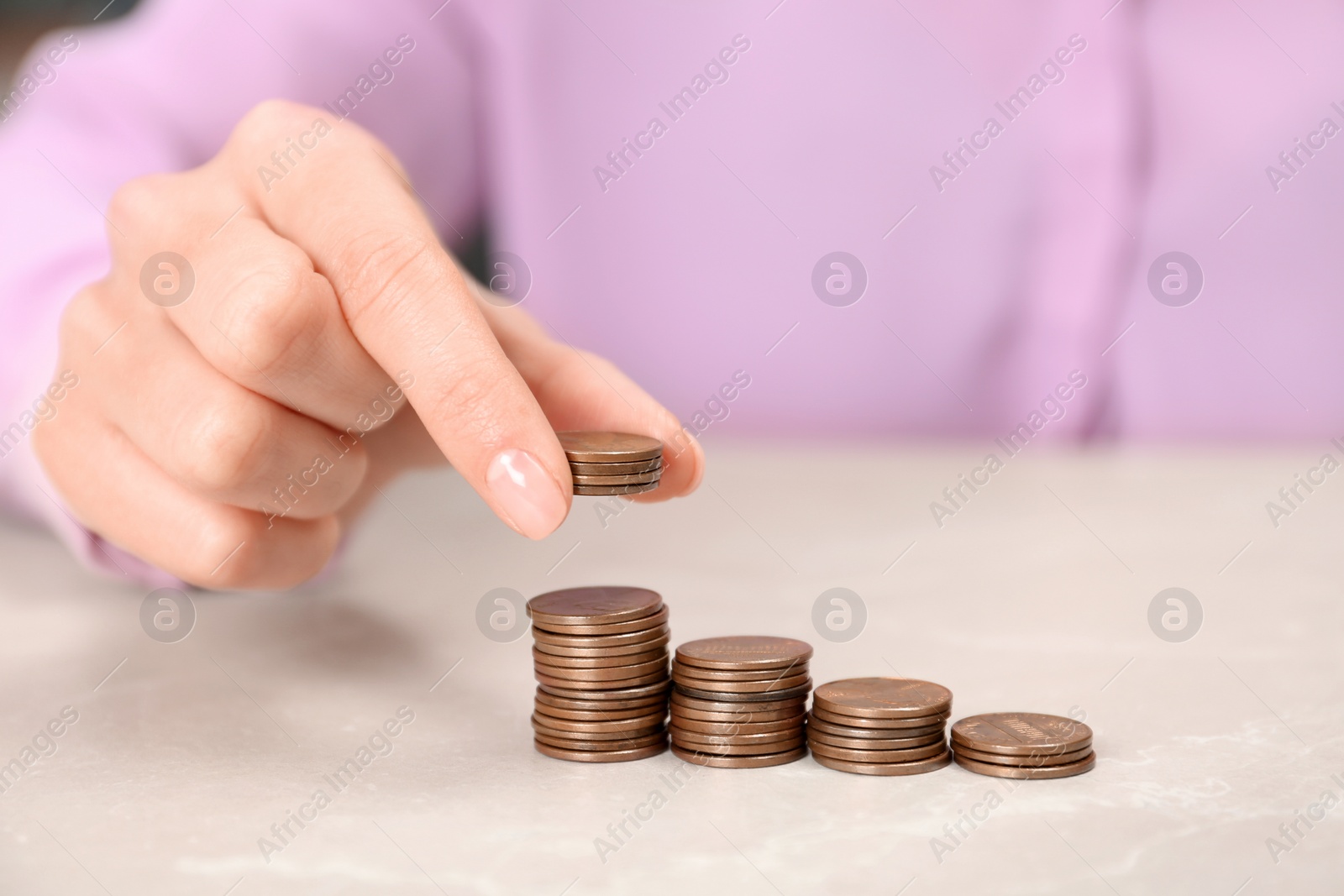 Photo of Woman counting coins at light table, closeup