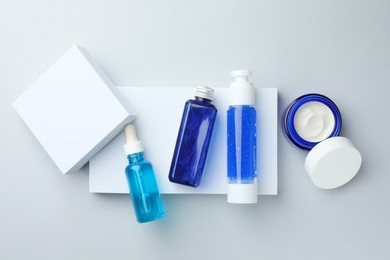 Set of cosmetic products on light grey background, flat lay