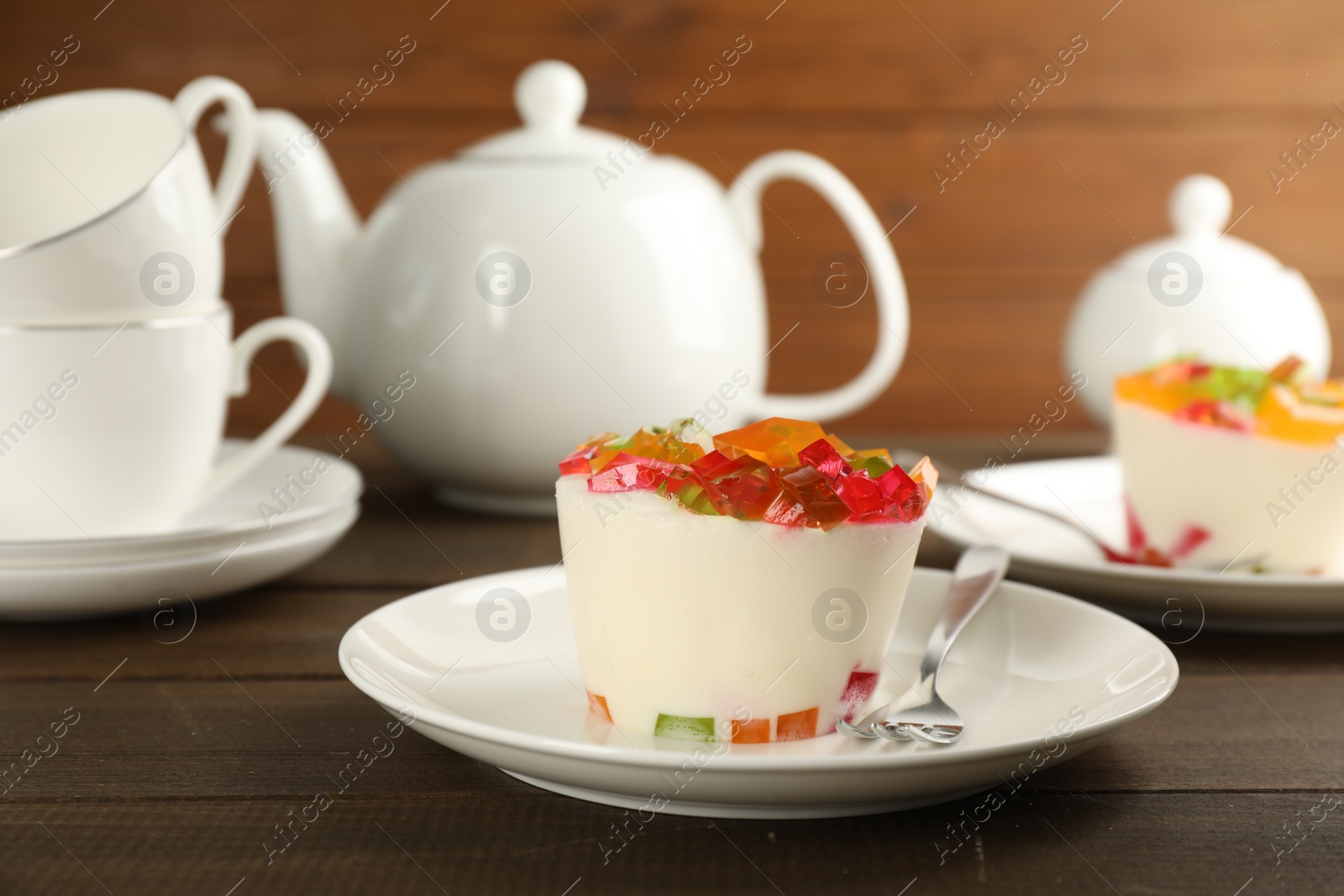 Photo of Delicious broken glass jelly dessert on wooden table