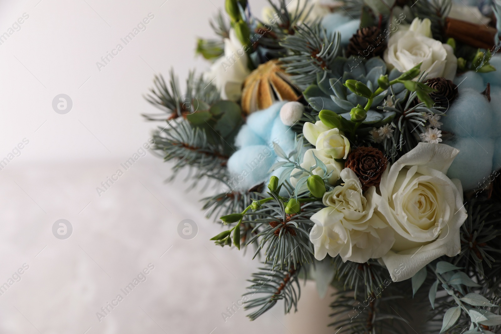 Photo of Beautiful wedding winter bouquet on light background, closeup