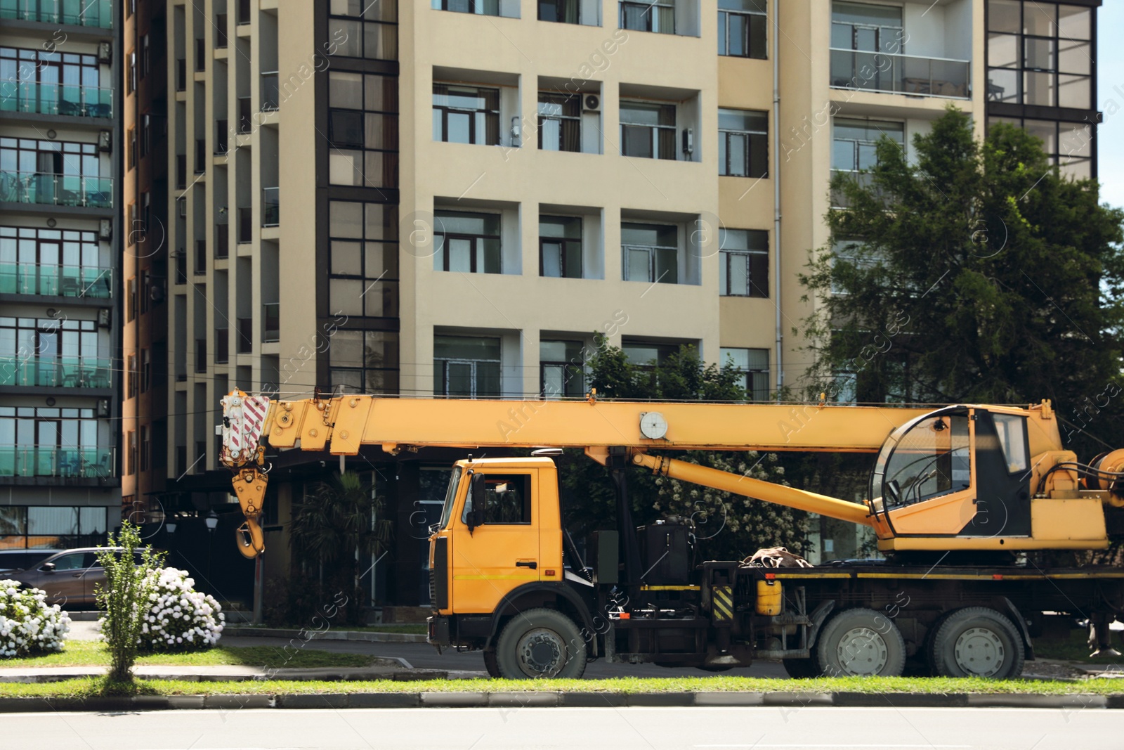 Photo of Construction site with crane truck near multistorey building