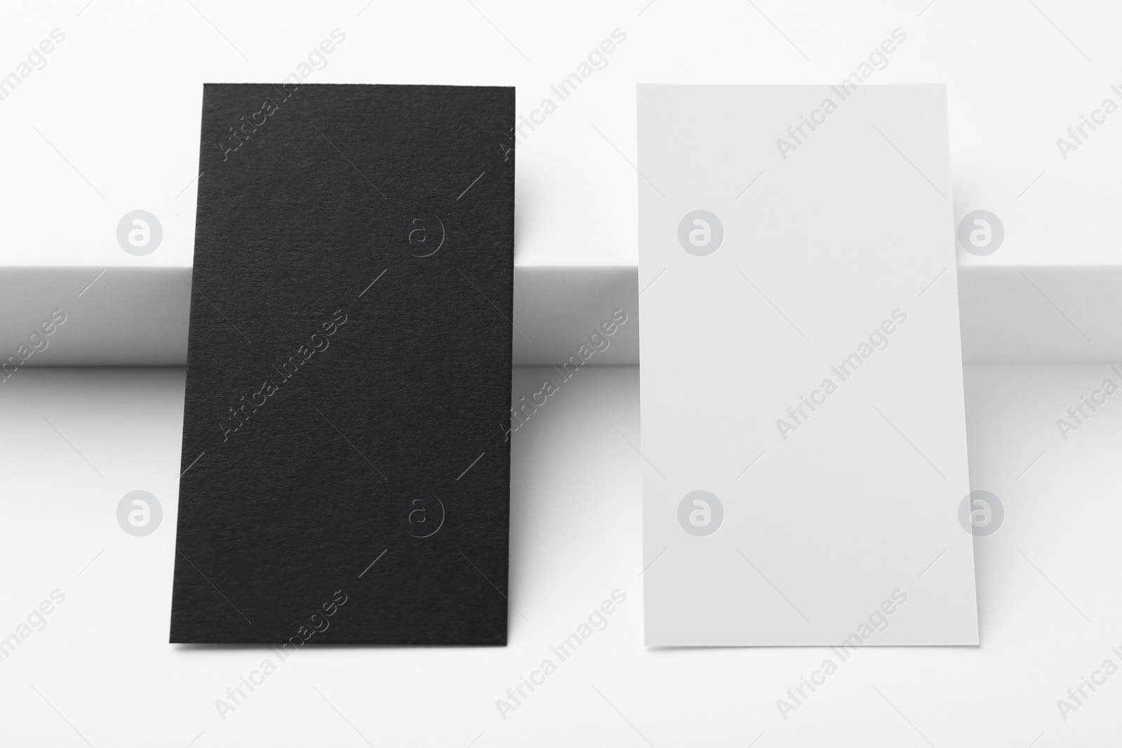 Photo of Business cards on white background, closeup. Mockup for design