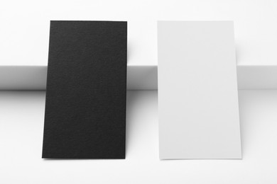 Photo of Business cards on white background, closeup. Mockup for design