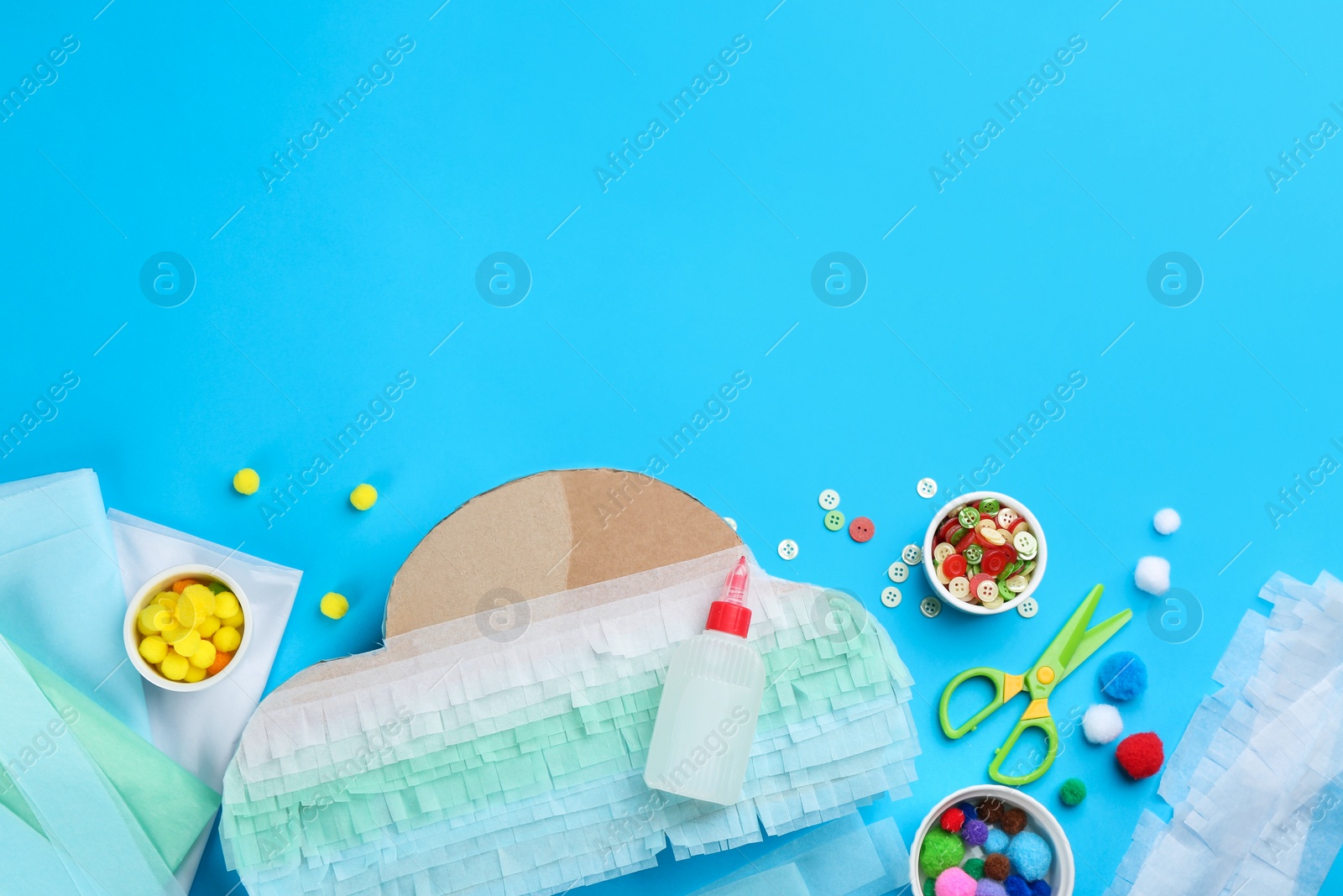 Photo of Flat lay composition with cardboard cloud on light blue background, space for text. Pinata diy