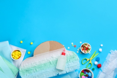 Flat lay composition with cardboard cloud on light blue background, space for text. Pinata diy