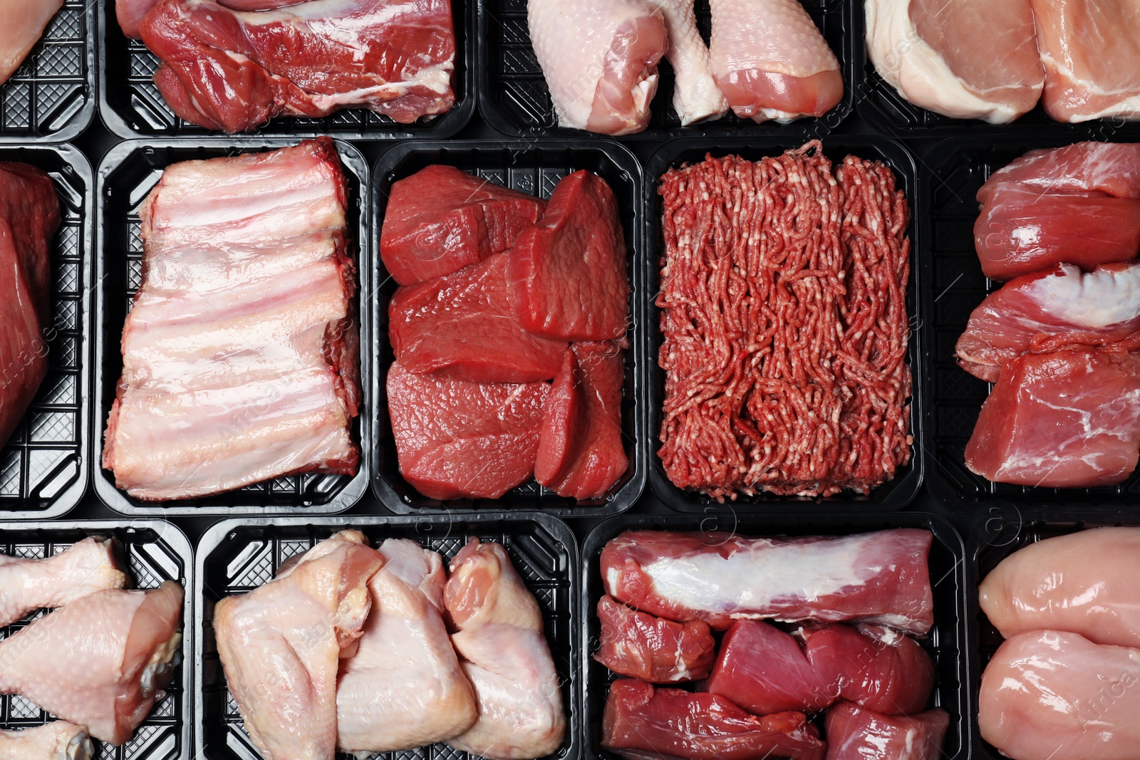 Photo of Containers with different raw meat, top view