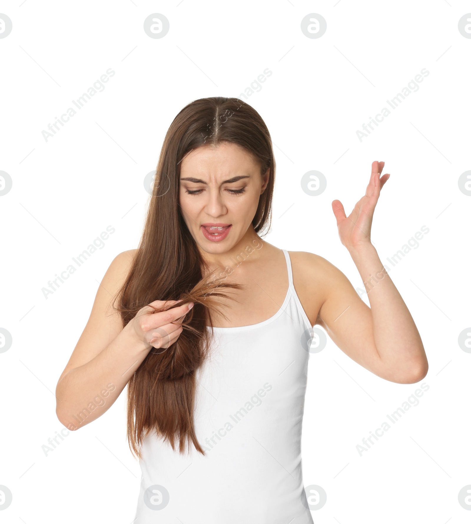 Photo of Emotional woman with damaged hair on white background. Split ends