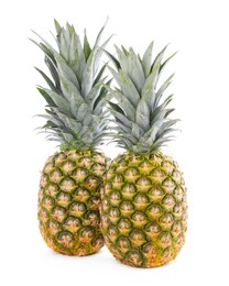 Photo of Two delicious ripe pineapples isolated on white