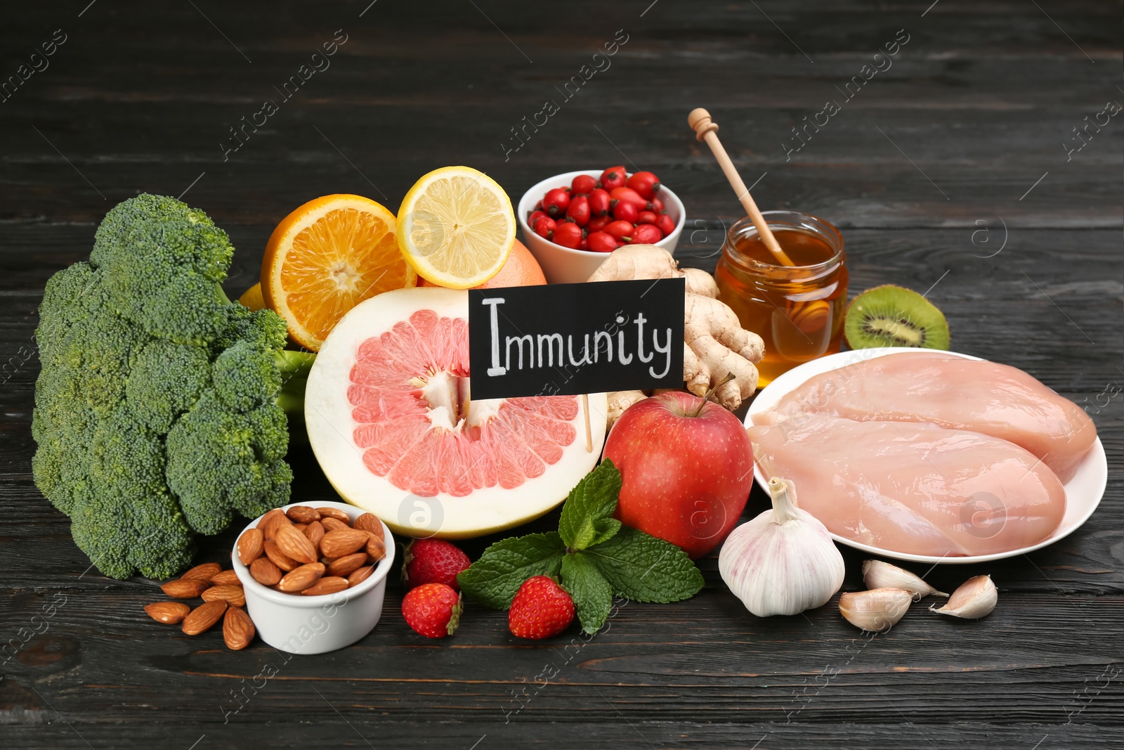 Photo of Card with word Immunity and fresh products on dark wooden table