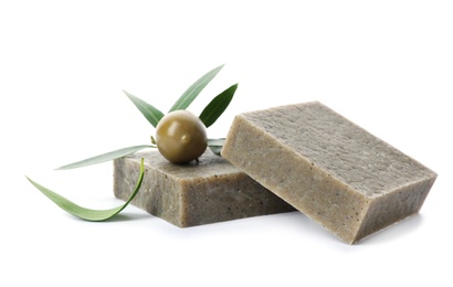 Handmade soap bars and leaves with olive on white background
