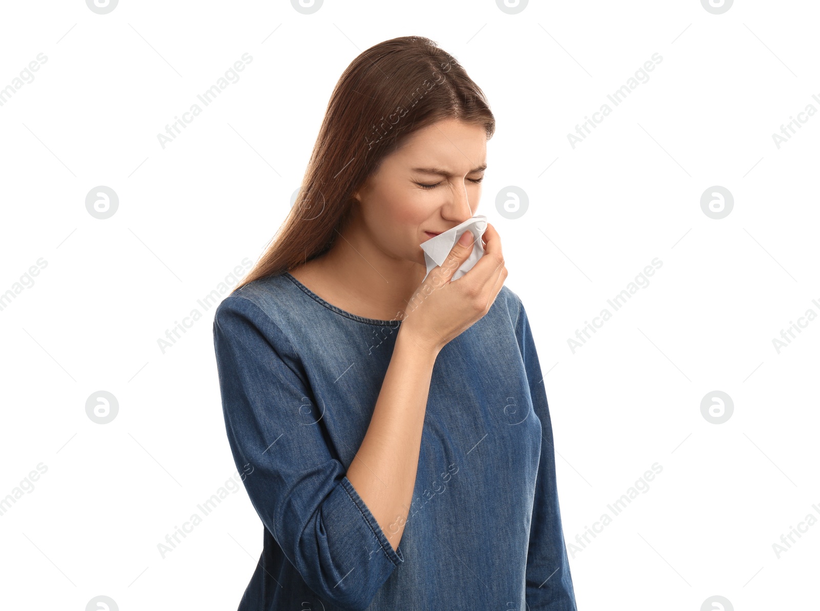 Photo of Young woman with tissue suffering from runny nose on white background