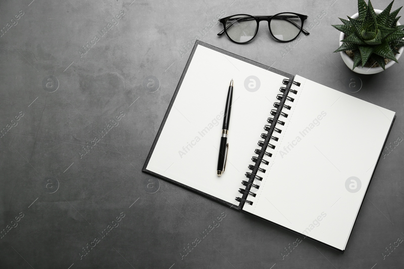 Photo of Flat lay composition with notebook on grey table