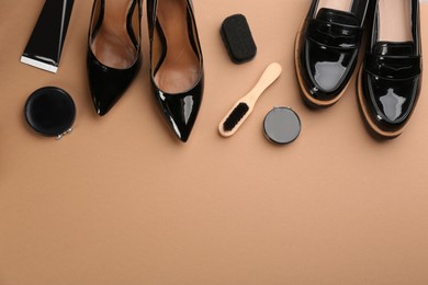 Flat lay composition with shoe care accessories and footwear on brown background. Space for text