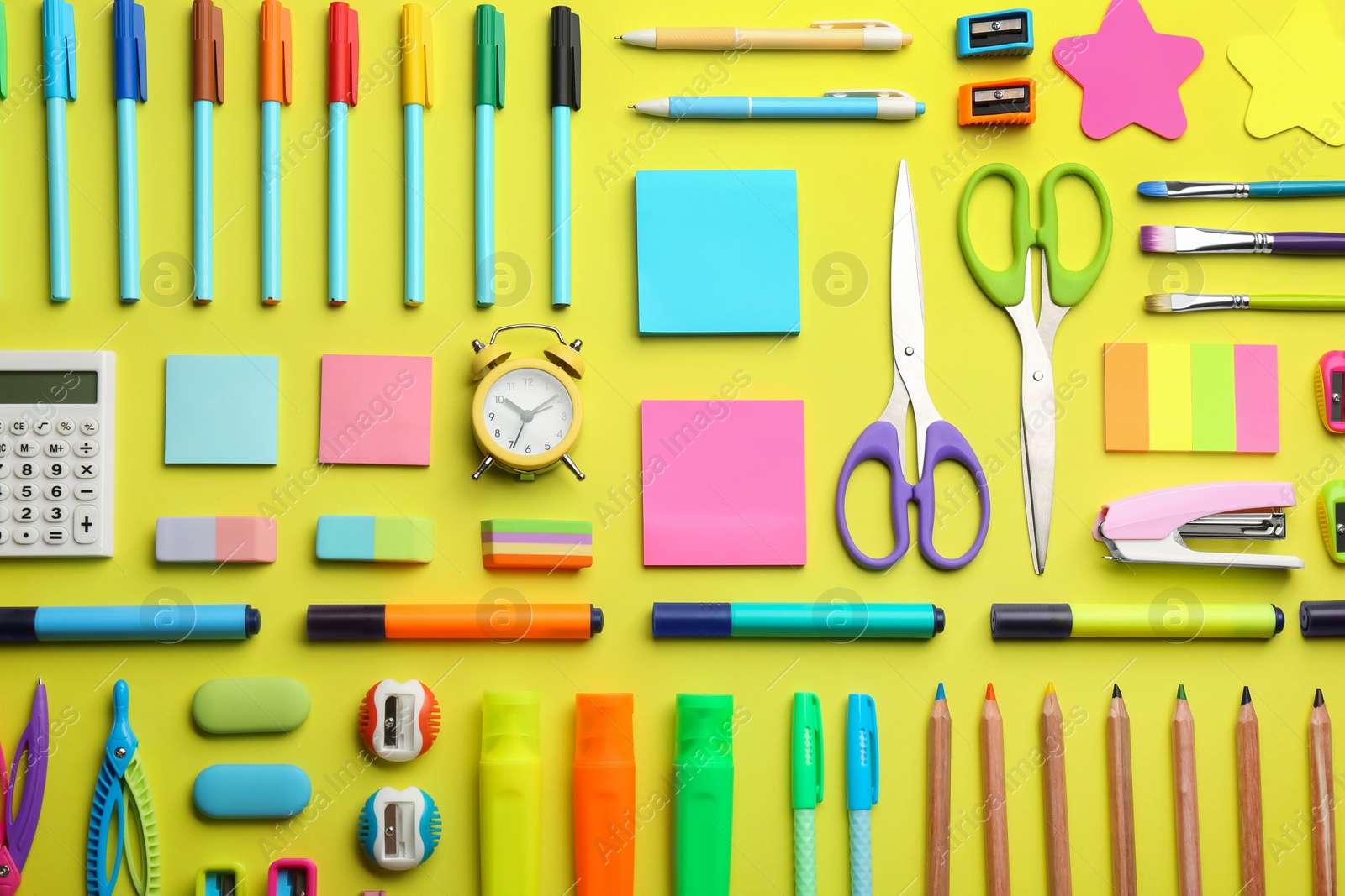 Photo of Flat lay composition with school stationery on yellow background. Back to school