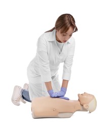 Photo of Doctor in uniform practicing first aid on mannequin against white background