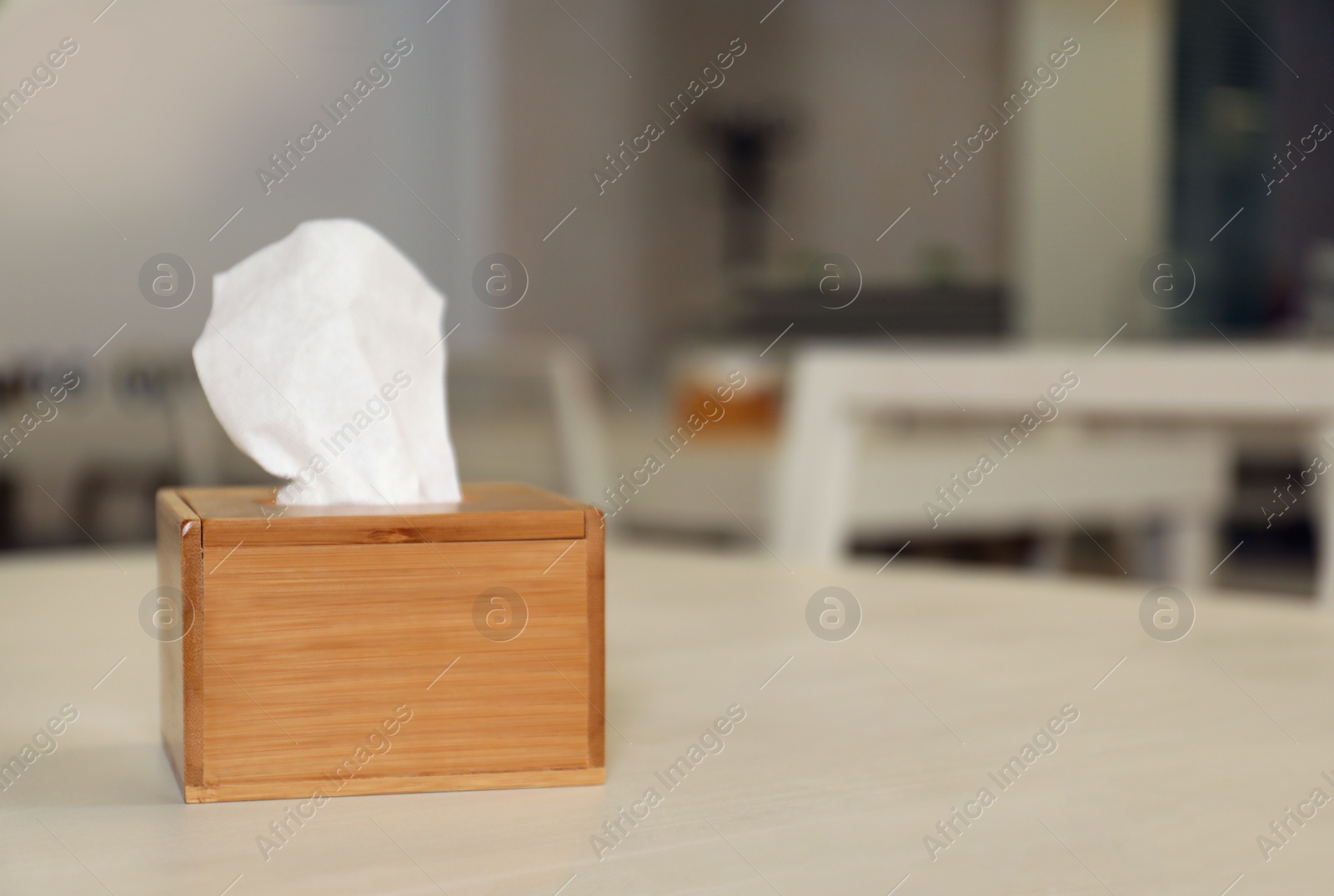 Photo of Wooden napkin holder on table in school canteen. Space for text