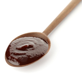 Spoon with hot barbecue sauce on white background