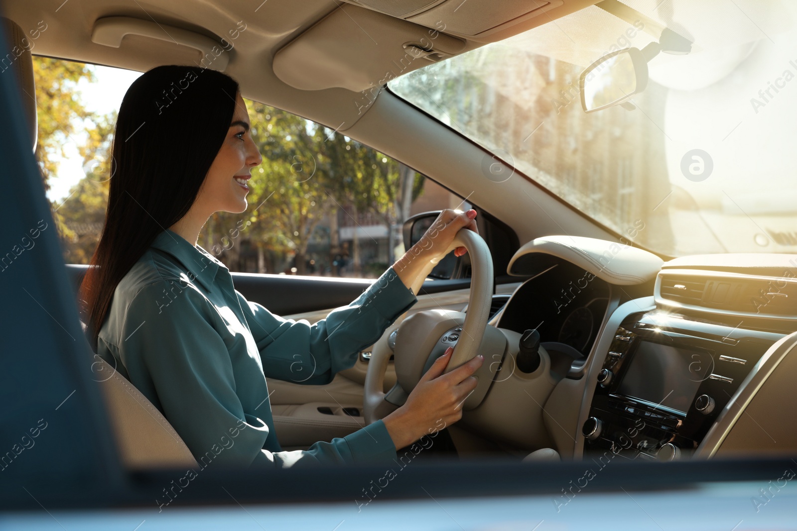 Photo of Beautiful young driver sitting in modern car