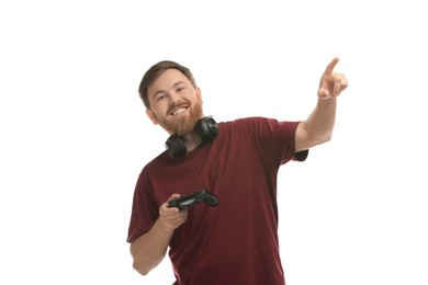 Photo of Happy man with game controller and headphones on white background