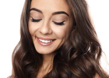 Beautiful woman with shiny wavy hair on white background