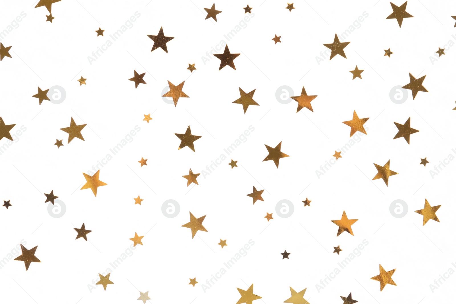 Photo of Star shaped golden confetti on white background, top view