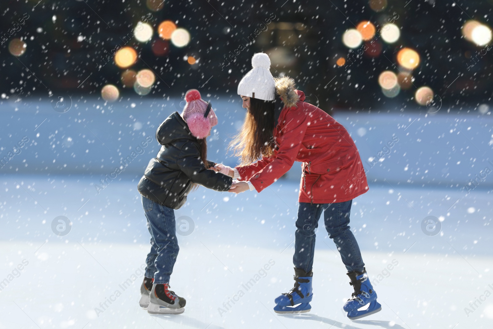 Image of Mother and daughter spending time together at outdoor ice skating rink