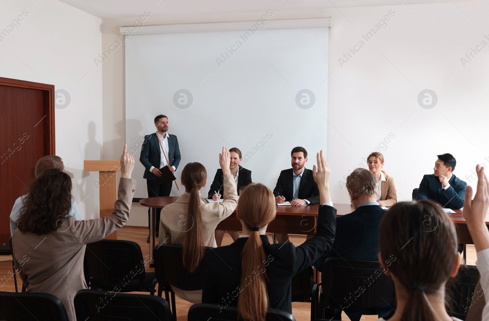 Photo of Business conference. People in meeting room listening to speaker report