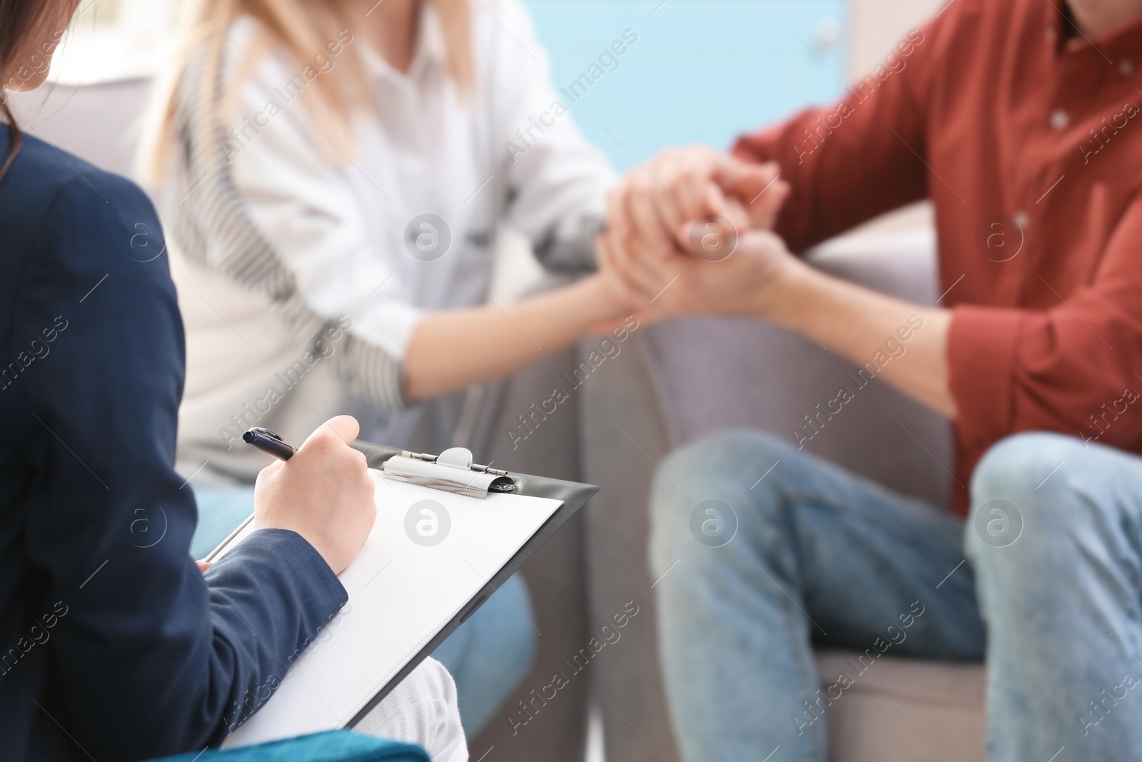 Photo of Family psychologist working with young couple in office, closeup