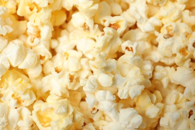 Photo of Fresh popcorn as background, closeup. Tasty snack