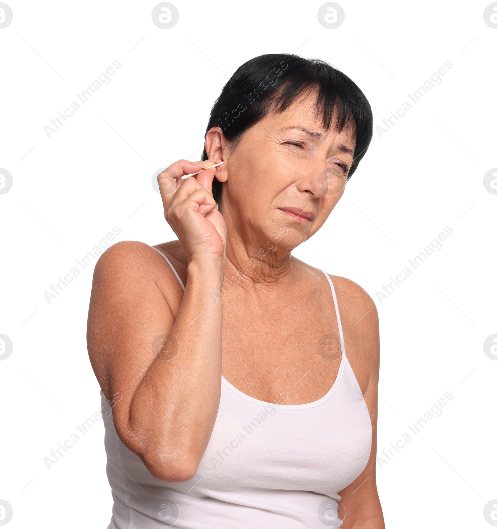 Photo of Senior woman cleaning ear with cotton swab on white background