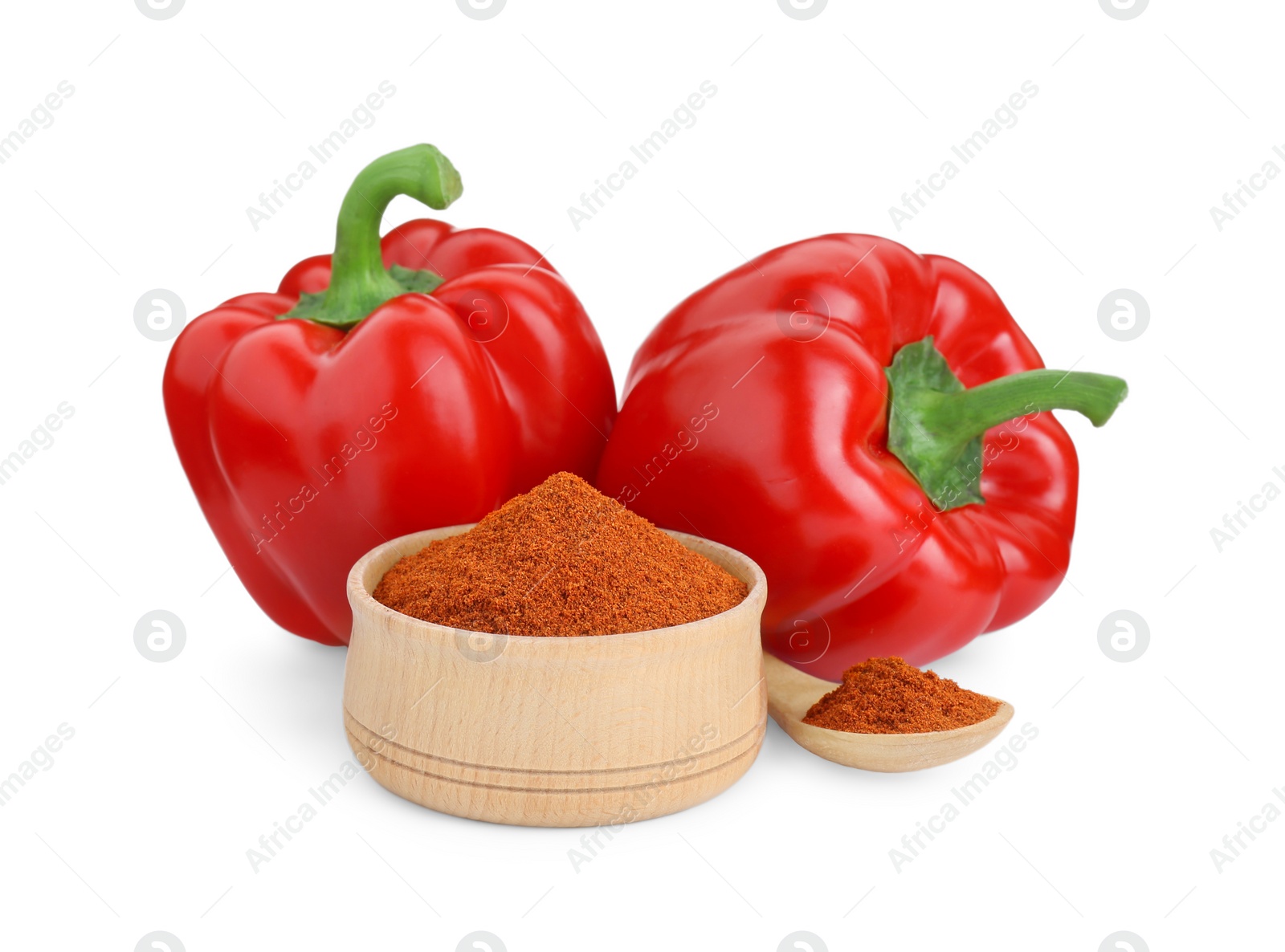 Photo of Bowl, spoon with aromatic paprika powder and fresh bell peppers isolated on white