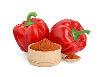 Photo of Bowl, spoon with aromatic paprika powder and fresh bell peppers isolated on white